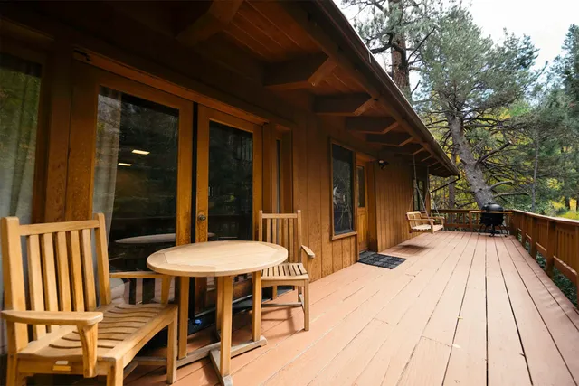 a view of a patio with a table and chairs and wooden floor