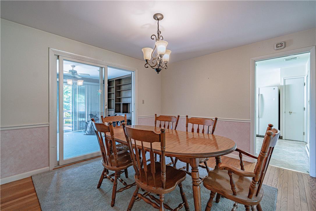 4815 Mill Road Schnecksville, PA 18078 - Photo 12 of 48 A classic chandelier illuminates this comfortable dining space, connecting to a bright sunroom through sliding doors.