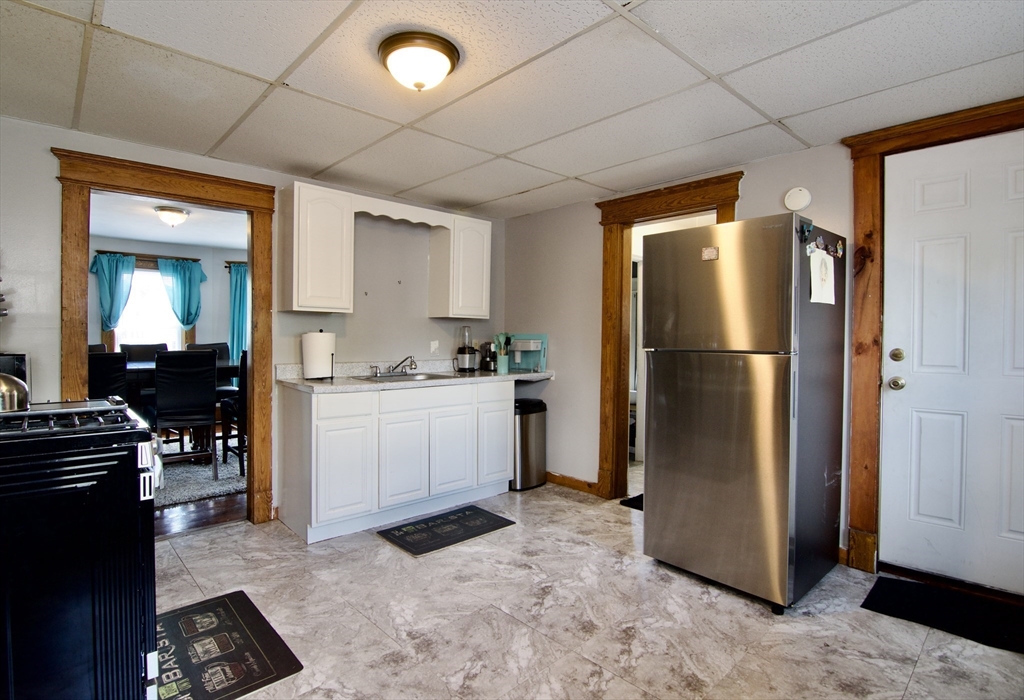 16 Amity Court Springfield, MA 01108 - Photo 15 of 42 a kitchen with a refrigerator and a stove