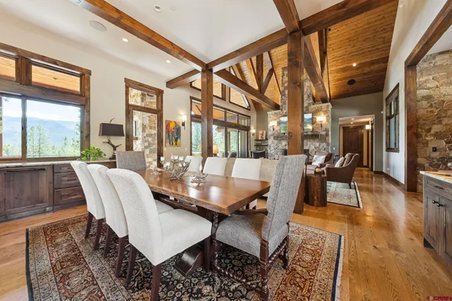a dining room with furniture a rug and a large window
