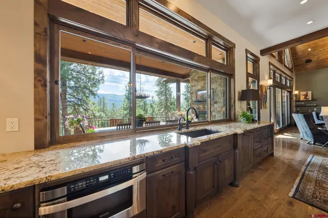 a kitchen with granite countertop a sink and cabinets