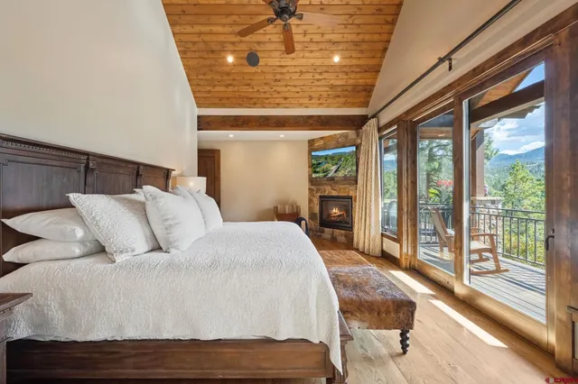 a bed sitting in a spacious bedroom next to a window