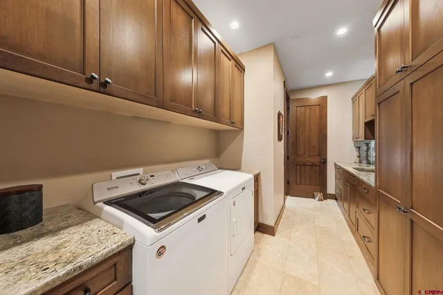 a kitchen that has a sink a stove and a refrigerator