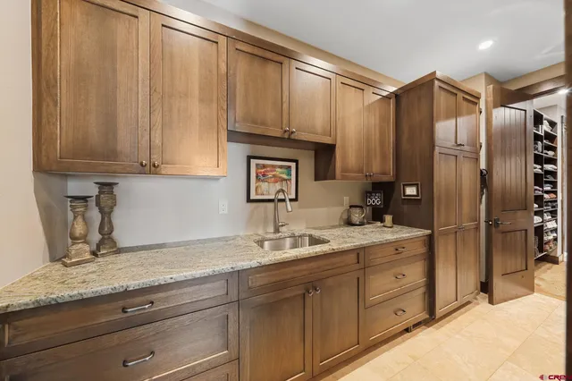 a kitchen with stainless steel appliances granite countertop a refrigerator and a sink