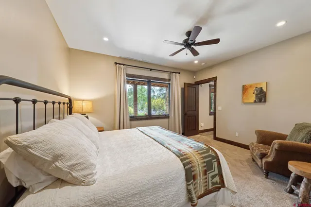 a bedroom with a large bed and a couch