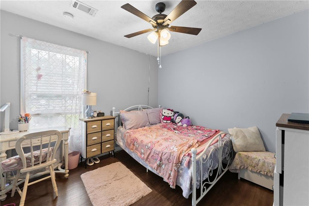 3615 South Bend Road Gainesville, GA 30506 - Photo 25 of 54 a bedroom with a bed and a chandelier