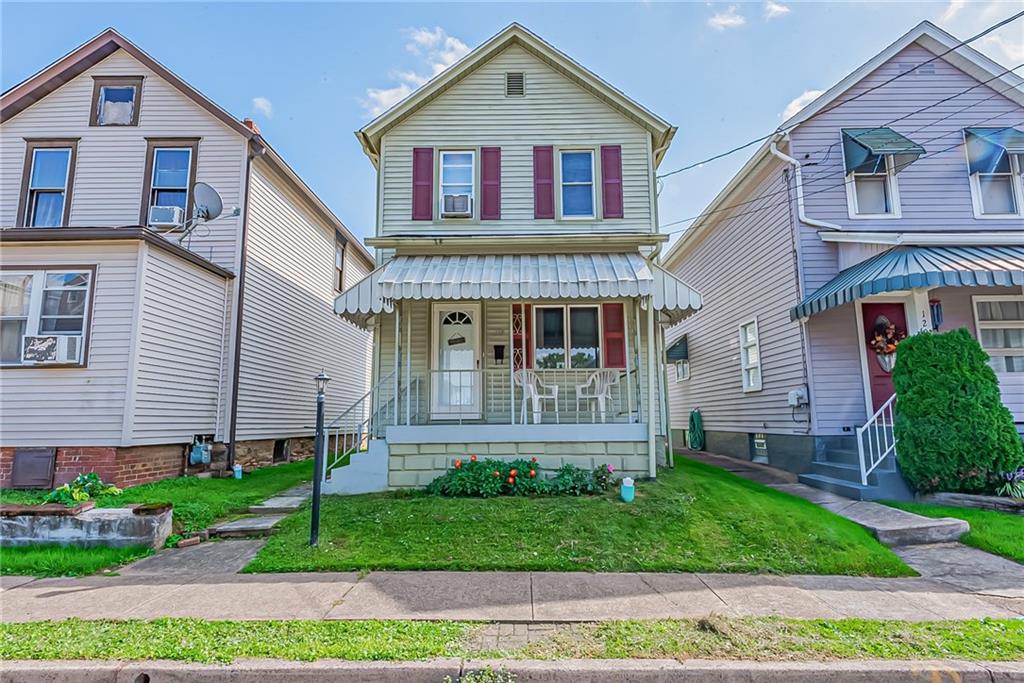 a front view of a house with a yard