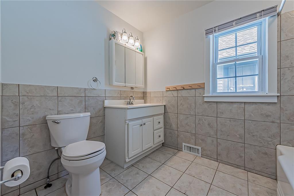 118 Ave A Latrobe, PA 15650 - Photo 15 of 25 a bathroom with a toilet sink and mirror