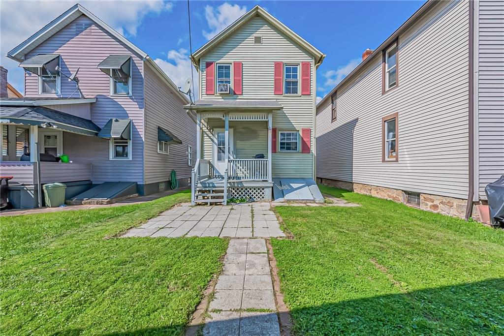 118 Ave A Latrobe, PA 15650 - Photo 23 of 25 a front view of a house with a yard and garage