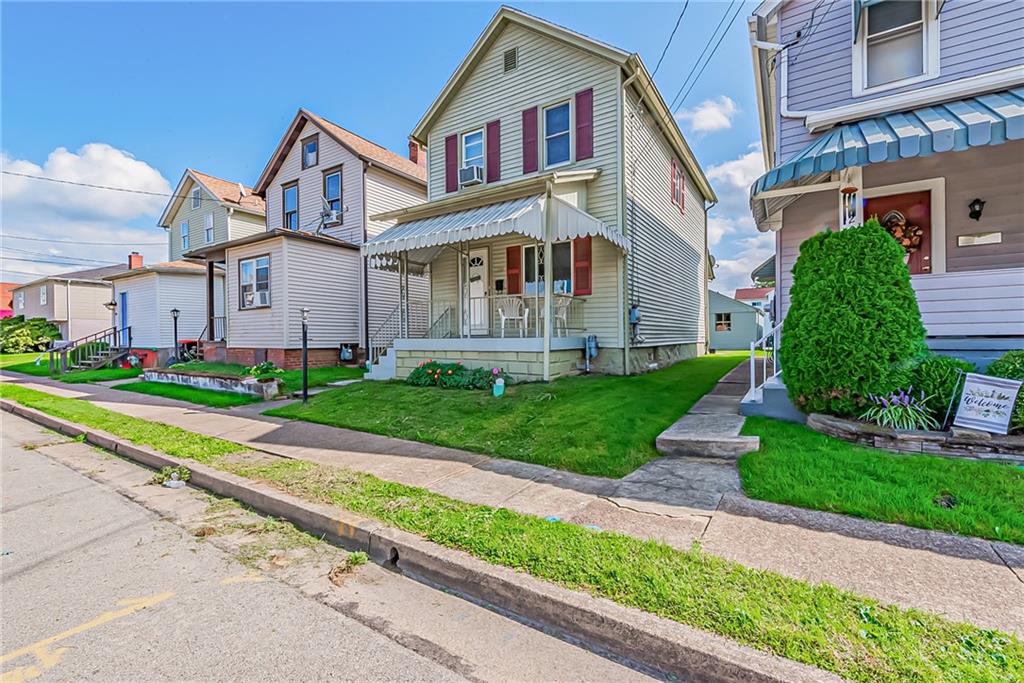 118 Ave A Latrobe, PA 15650 - Photo 24 of 25 a front view of a house with a yard and potted plants