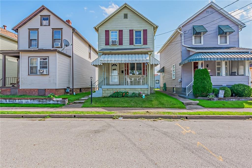 118 Ave A Latrobe, PA 15650 - Photo 25 of 25 a front view of a house with a yard and potted plants