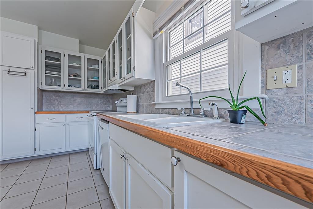 118 Ave A Latrobe, PA 15650 - Photo 8 of 25 a kitchen with cabinets a sink and a window