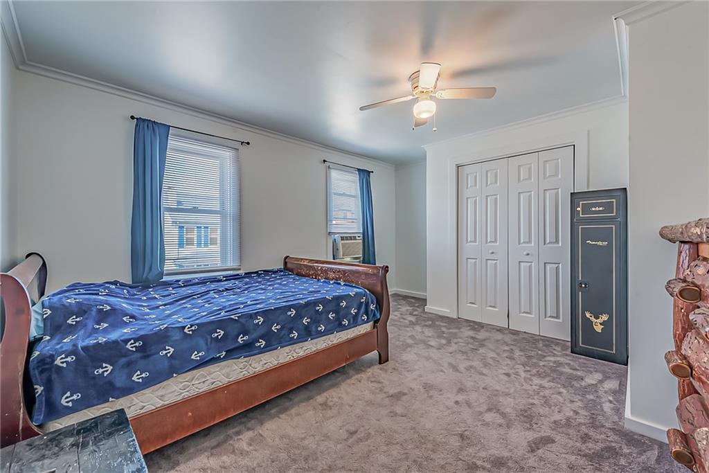 118 Ave A Latrobe, PA 15650 - Photo 9 of 25 a bedroom with a bed and a chandelier