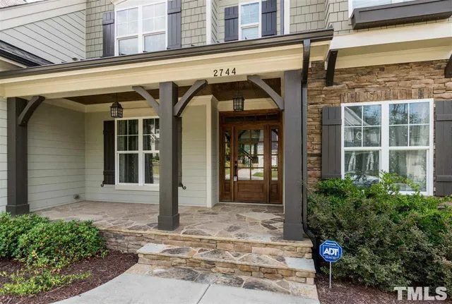 a view of front door with wooden floor and stairs