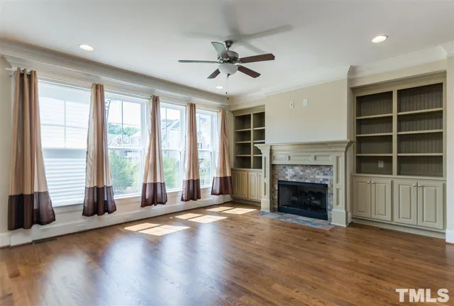 a kitchen with stainless steel appliances granite countertop a stove top oven a sink dishwasher a refrigerator and a dining table with wooden floor