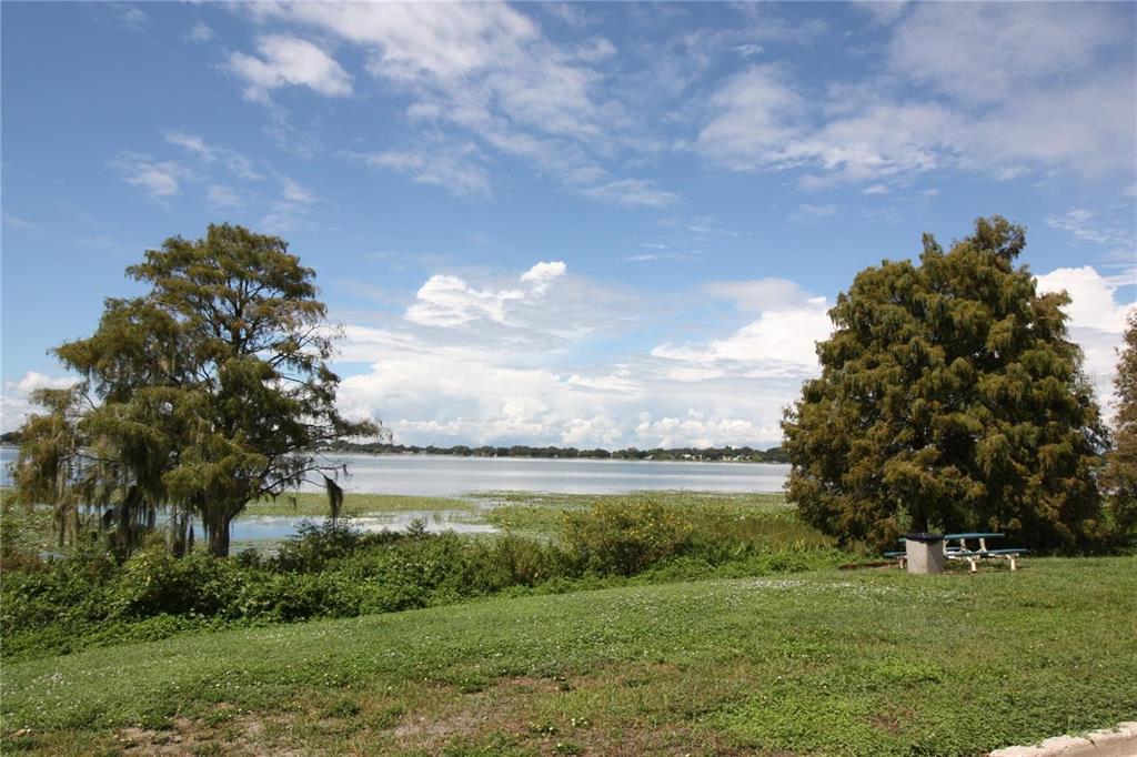 521 20th Street Southwest, Unit C Winter Haven, FL 33880 - Photo 17 of 18 a view of a lake with a big yard