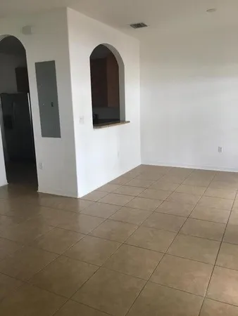 a kitchen with granite countertop a stove top oven microwave and cabinets