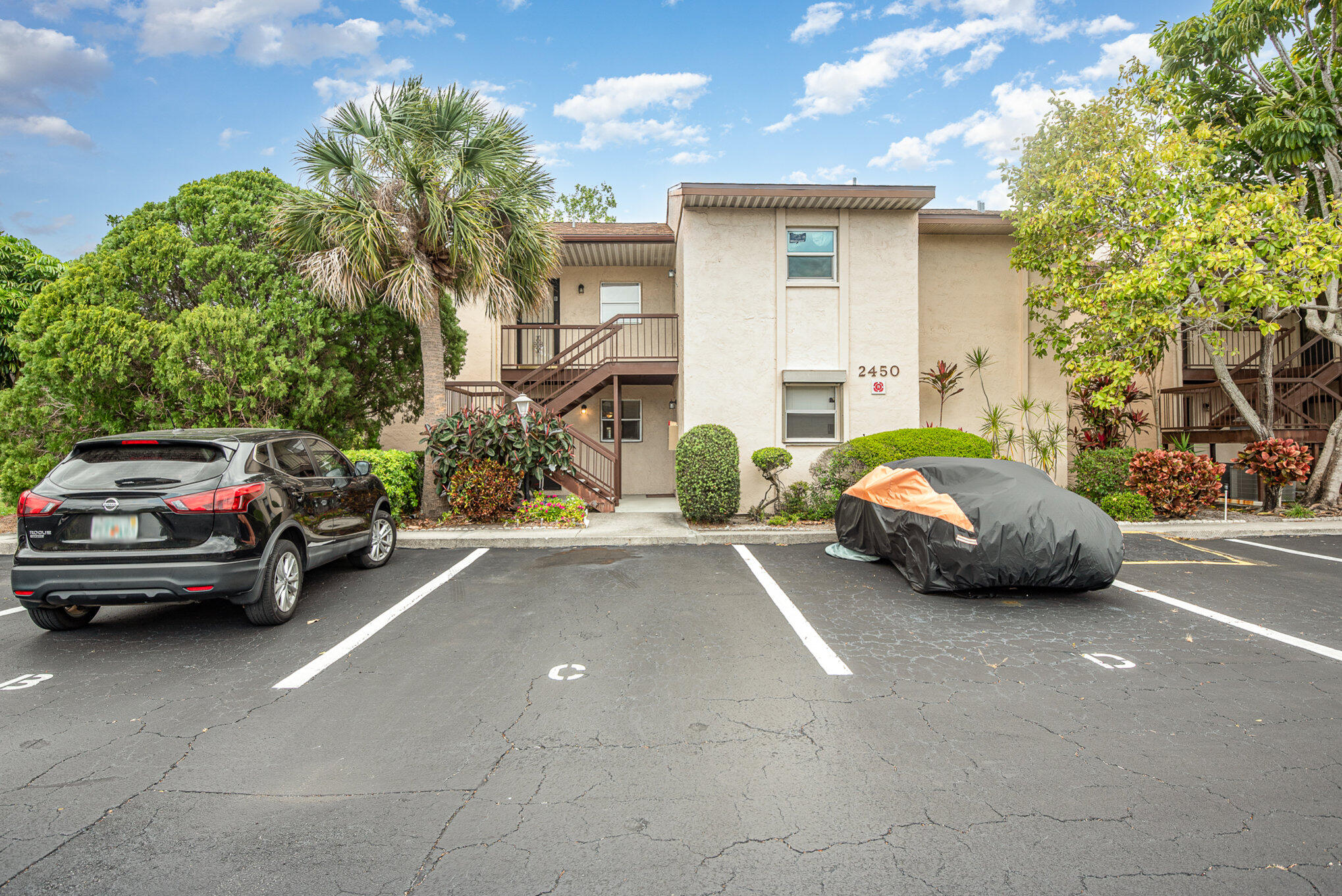 2450 Lake Washington Road, Unit 7A Melbourne, FL 32935 - Photo 1 of 24 a view of cars parked in front of a house