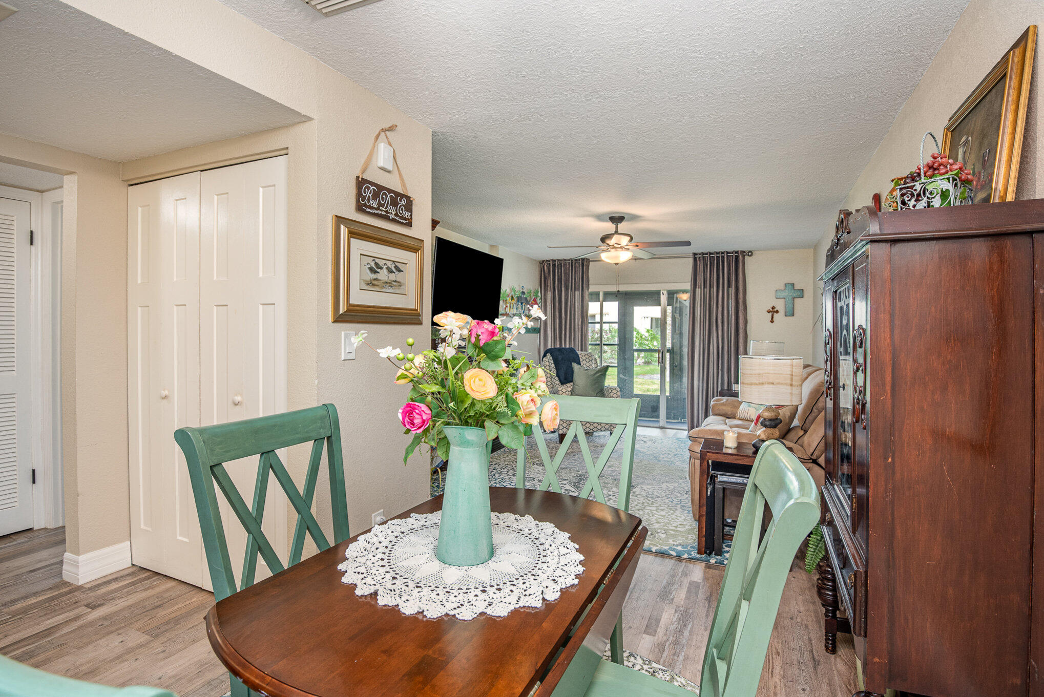 2450 Lake Washington Road, Unit 7A Melbourne, FL 32935 - Photo 12 of 24 a view of a dining room with furniture a potted plant and wooden floor
