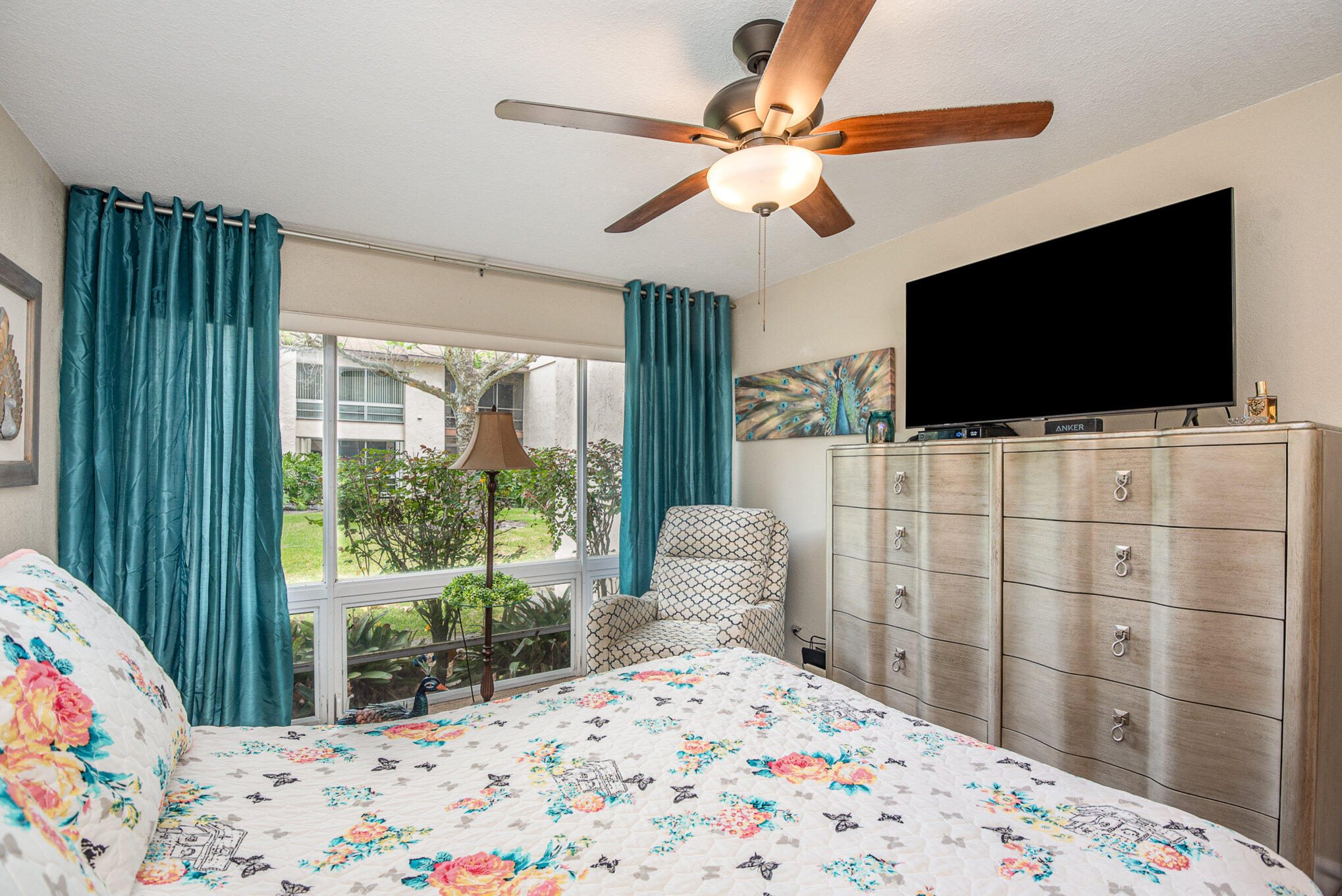 2450 Lake Washington Road, Unit 7A Melbourne, FL 32935 - Photo 15 of 24 a bedroom with a bed and a flat screen tv