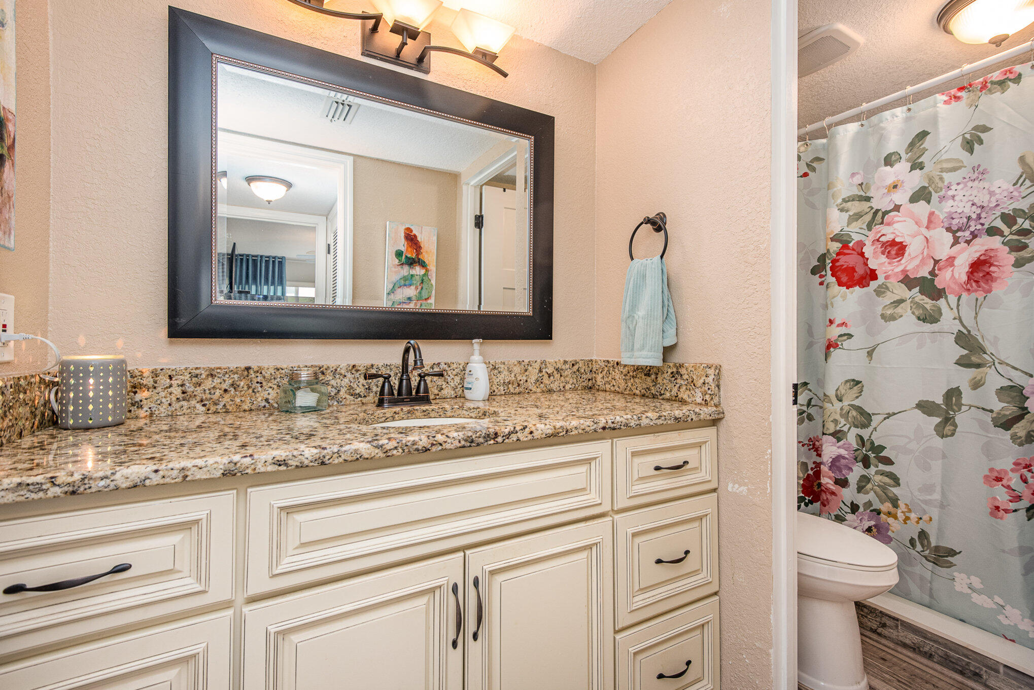 2450 Lake Washington Road, Unit 7A Melbourne, FL 32935 - Photo 17 of 24 a bathroom with a granite countertop sink vanity mirror and toilet