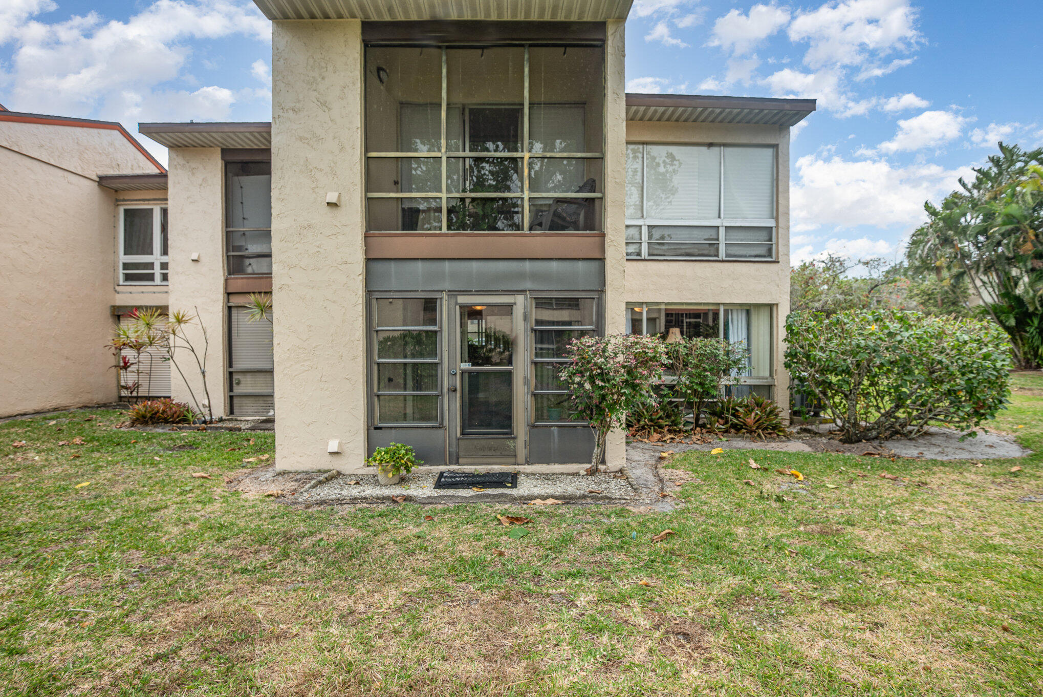 2450 Lake Washington Road, Unit 7A Melbourne, FL 32935 - Photo 20 of 24 a house with trees in front of it