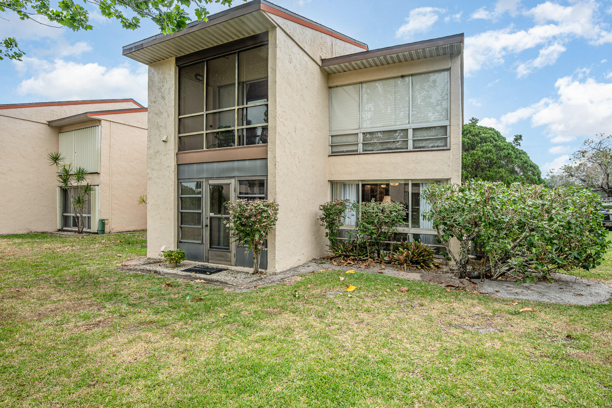 2450 Lake Washington Road, Unit 7A Melbourne, FL 32935 - Photo 22 of 24 a front view of a house with a yard