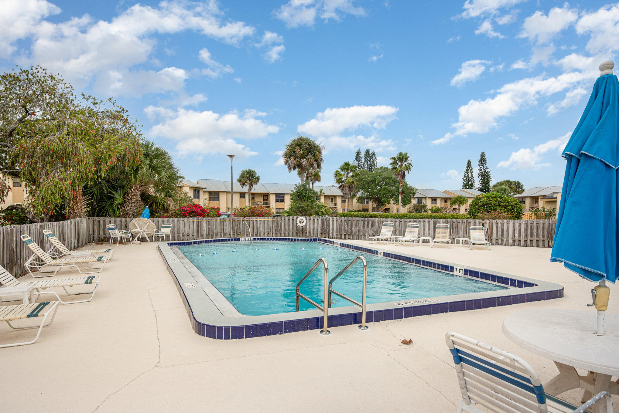 2450 Lake Washington Road, Unit 7A Melbourne, FL 32935 - Photo 23 of 24 a view of a swimming pool with a lounge chair