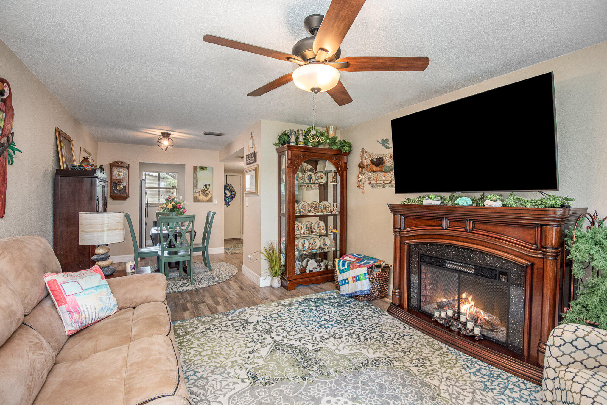 2450 Lake Washington Road, Unit 7A Melbourne, FL 32935 - Photo 5 of 24 a living room with furniture a flat screen tv and a fireplace