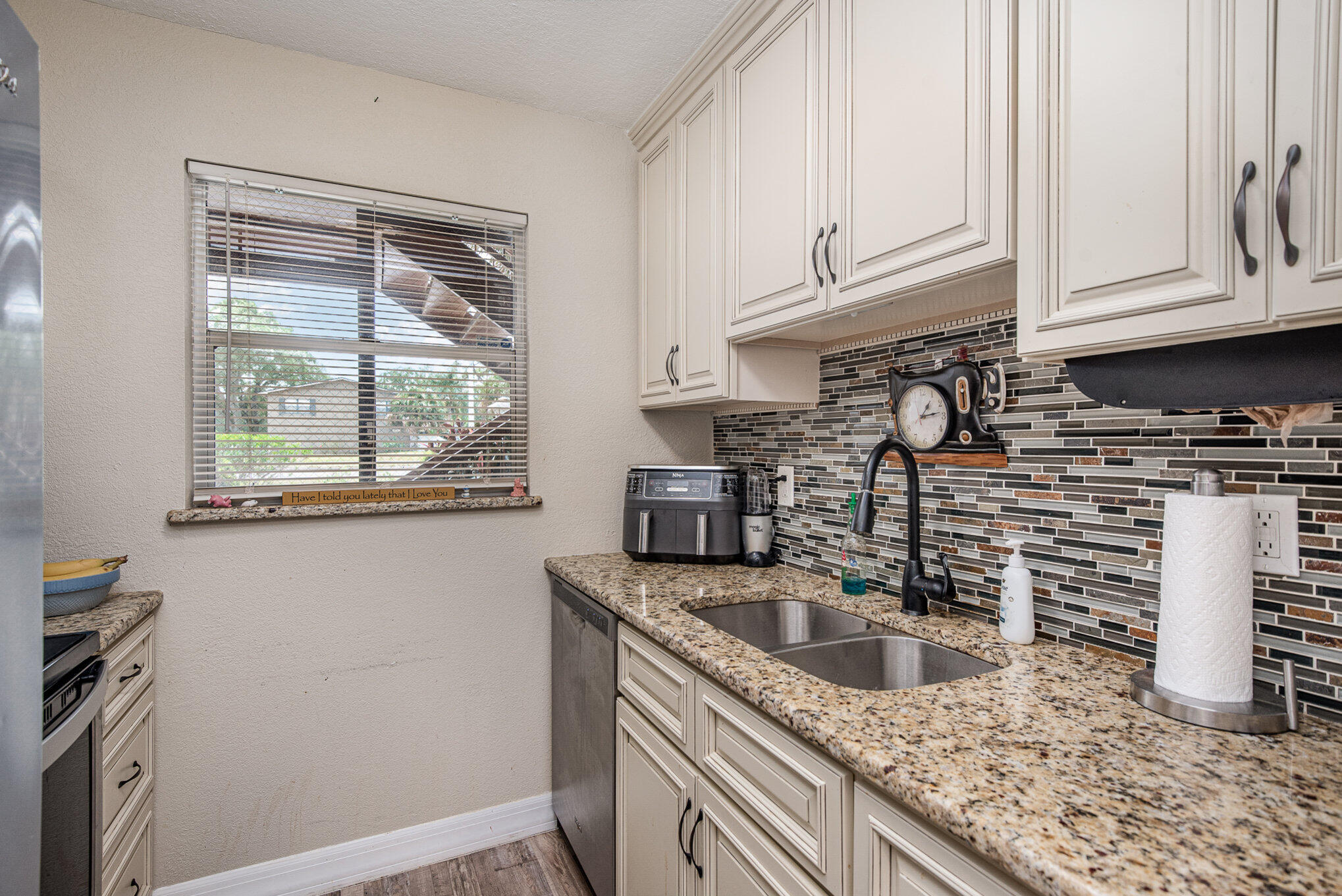 2450 Lake Washington Road, Unit 7A Melbourne, FL 32935 - Photo 6 of 24 a kitchen with granite countertop a sink a stove and cabinets
