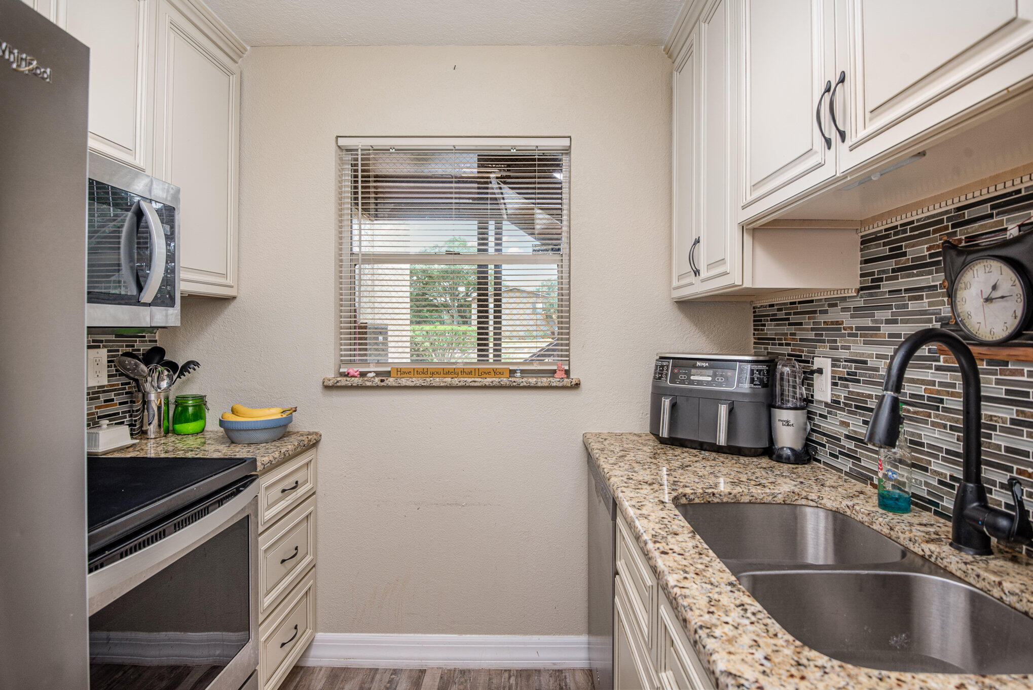 2450 Lake Washington Road, Unit 7A Melbourne, FL 32935 - Photo 7 of 24 a kitchen with granite countertop a sink stainless steel appliances and cabinets