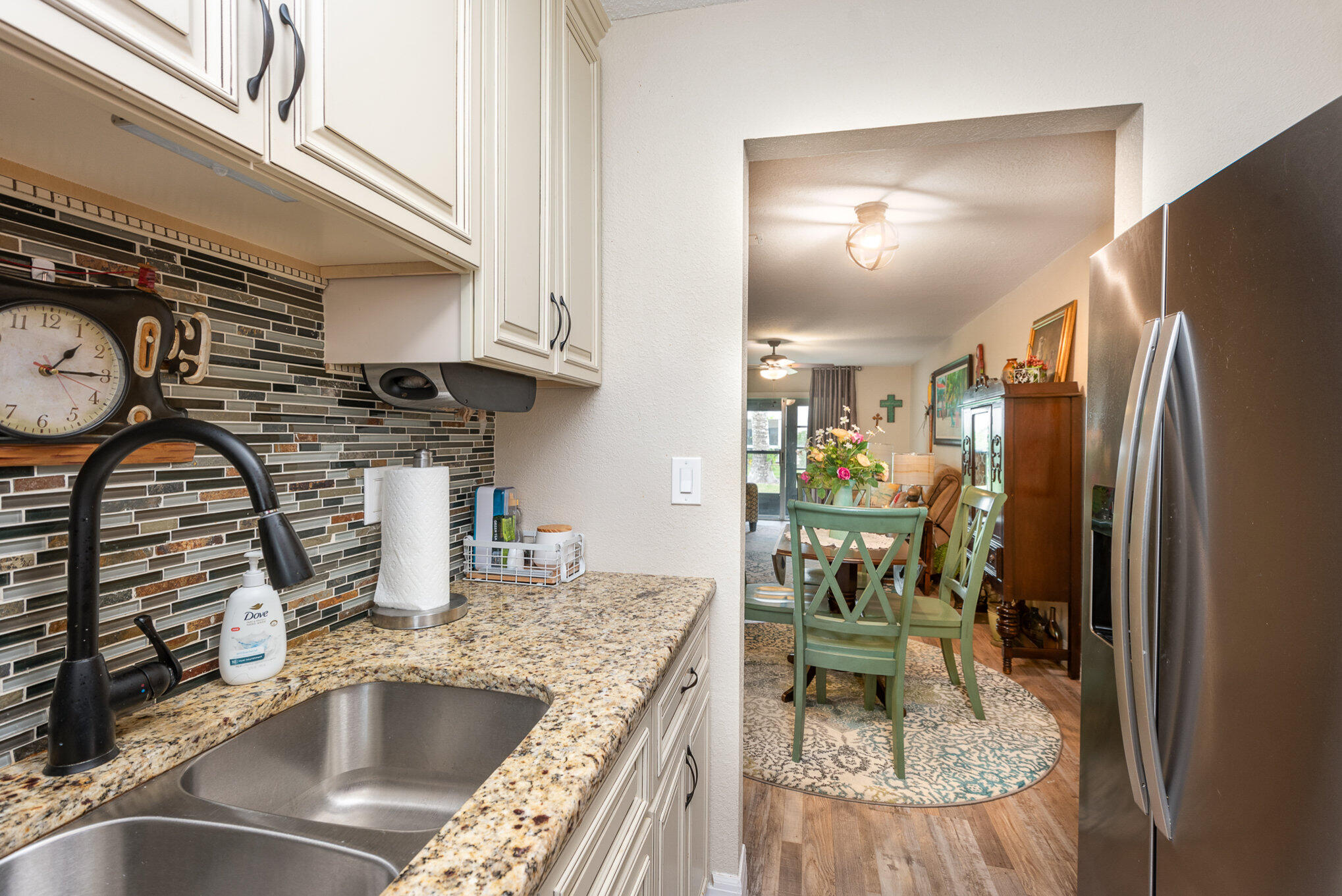 2450 Lake Washington Road, Unit 7A Melbourne, FL 32935 - Photo 8 of 24 a kitchen with stainless steel appliances granite countertop a sink and a refrigerator