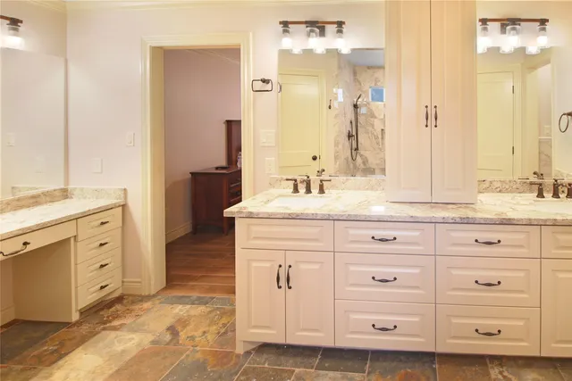 a bathroom with a sink vanity and mirror