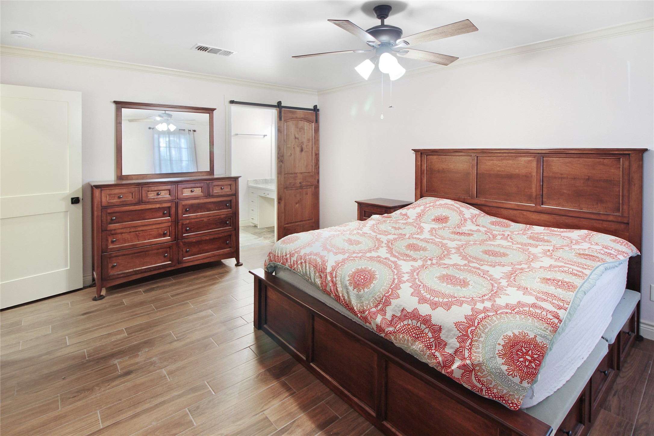 7531 Ralick Court Spring, TX 77379 - Photo 26 of 42 a spacious bedroom with a bed and a chandelier