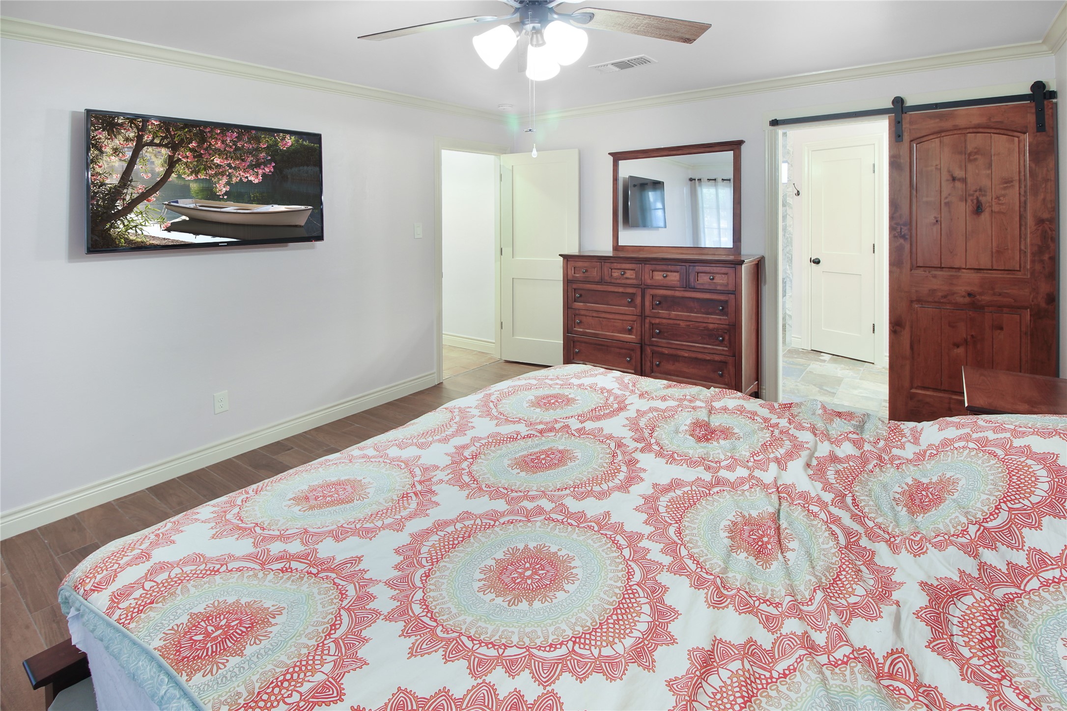 7531 Ralick Court Spring, TX 77379 - Photo 27 of 42 a bedroom with a bed and a chandelier