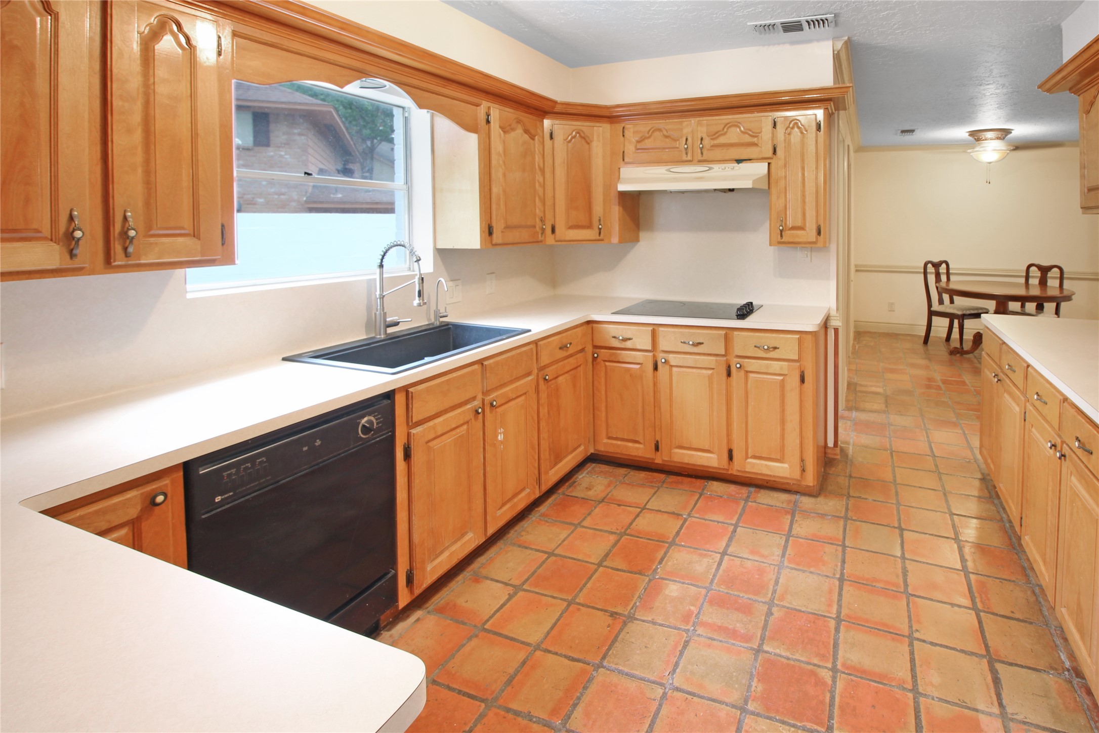 7531 Ralick Court Spring, TX 77379 - Photo 3 of 42 a kitchen with a sink a stove and cabinets