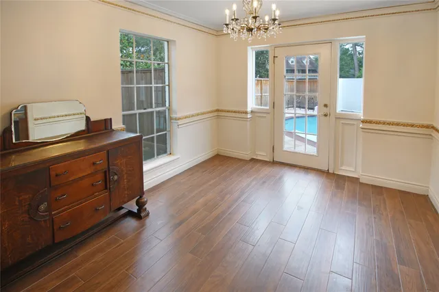 a view of a room with wooden floor and windows