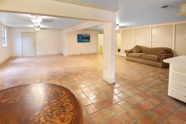 a living room with a couch and a stove top oven