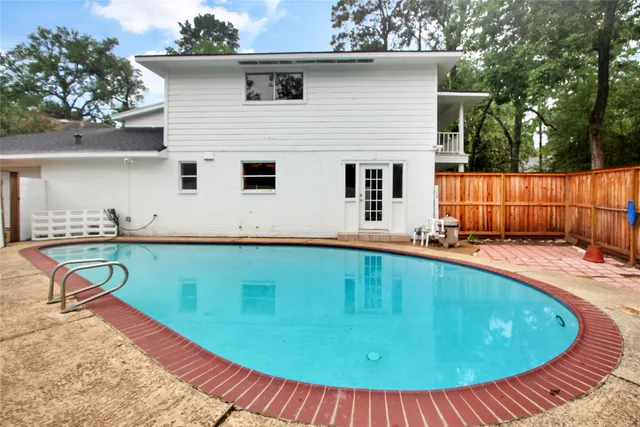 a view of a backyard with a small swimming pool