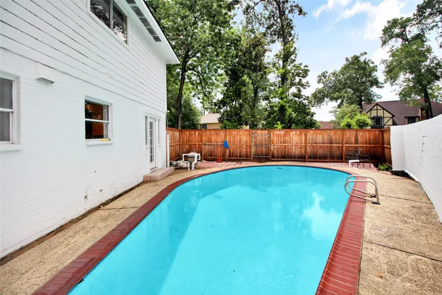 a view of a backyard with wooden fence