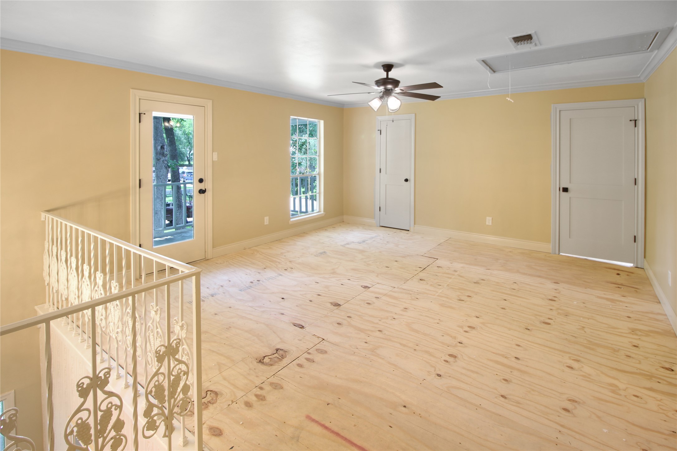 7531 Ralick Court Spring, TX 77379 - Photo 5 of 42 Upstairs Game Room or upstairs Living Room with door to upstairs balcony. New Fans and lights and paint in 2024. Floor ready for new owner to install Luxury Vinyl Plank (LVP) or carpet.