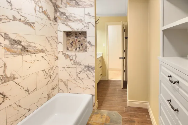 a bathroom with a bathtub and shower