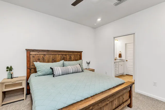 a bedroom with a bed and lamps