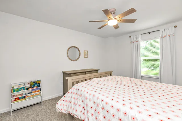 a bedroom with a bed and a painting on the wall