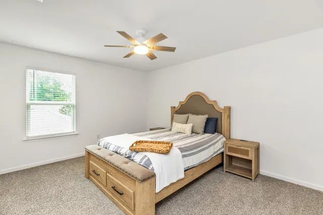 a bedroom with a bed and window