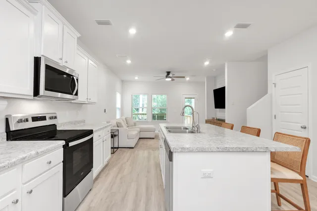 a kitchen with a sink microwave and stove