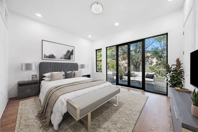 a bedroom with a large bed and a large window