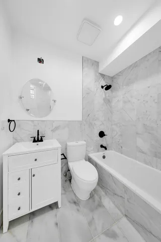 a bathroom with a sink a toilet and a bathtub