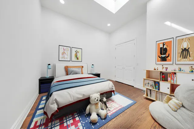 a bedroom with a bed and a book shelf