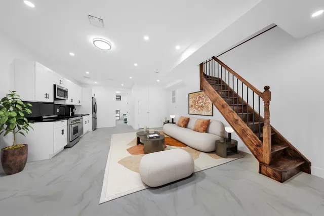 a living room with furniture and a potted plant